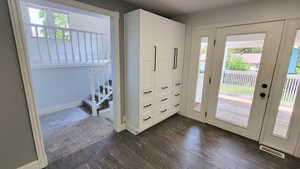 Doorway to outside with plenty of natural light and wood finished floors