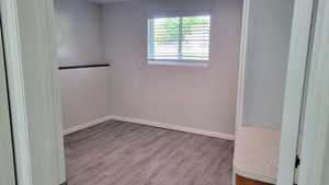 Unfurnished room featuring wood finished floors and baseboards