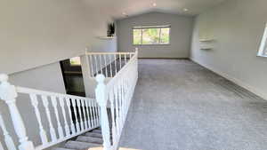 Stairway with carpet, lofted ceiling, and recessed lighting