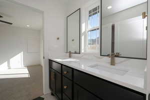 Jack n Jill Bathroom featuring double vanity and recessed lighting