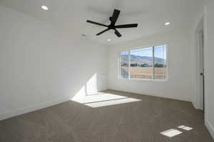 Carpeted spare room with a mountain view, recessed lighting, and a ceiling fan