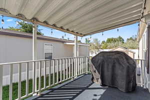 View of patio featuring grilling area and a sunroom