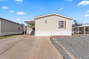 View of side of property featuring concrete driveway