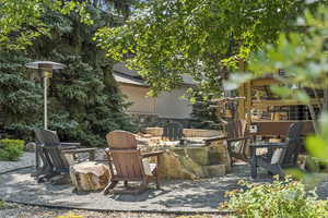 View of patio featuring a fire pit and area for grilling