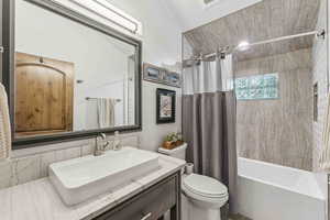 Full bathroom with shower / bathtub combination with curtain and vanity