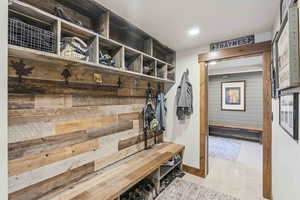 Mudroom with wood walls and recessed lighting