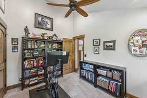 Office area featuring light carpet and a ceiling fan