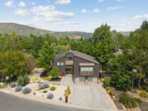 Mid-century modern home with a mountain view and decorative driveway