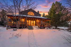 View of front facade with a porch and a chimney