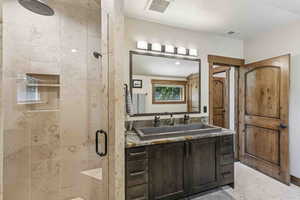 Bathroom with a shower stall and vanity