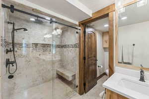Full bath featuring vanity, a stall shower, and recessed lighting