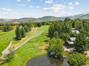Aerial view of a mountainous background and a golf club