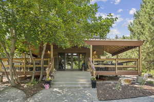 Entrance to property featuring a wooden deck and french doors