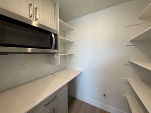 Unfurnished office with dark wood finished floors and baseboards