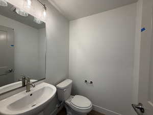 Bathroom featuring a textured ceiling and wood finished floors
