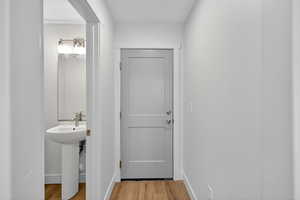 Bathroom with light wood-style floors and baseboards