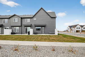 Back of property with a yard and a residential view