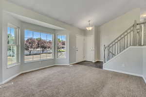 Foyer with carpet and stairway