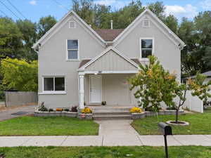 View of front of home featuring stucco siding and covered porch
