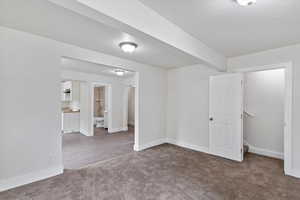 Main level living room with view to kitchen and entry to stairs leading up to east side loft with master bedroom and ensuite