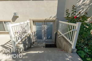 Doorway to property with stucco siding and french doors