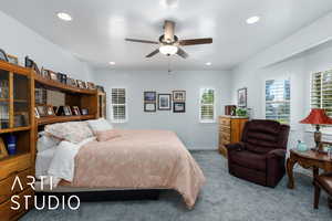 Carpeted bedroom featuring ceiling fan and recessed lighting