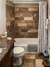 Bathroom featuring shower / bath combination with curtain and vanity