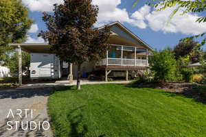 View of front of house featuring a front yard and asphalt driveway