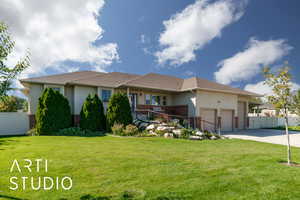Ranch-style house featuring brick siding, stucco siding, an attached garage, driveway, and roof with shingles