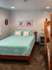 Bedroom featuring dark carpet and recessed lighting