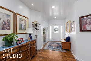 Entrance foyer with dark wood-style flooring and recessed lighting