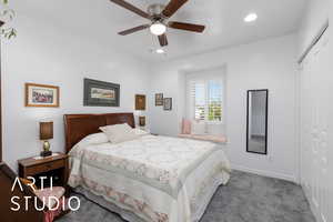 Carpeted bedroom featuring a closet, ceiling fan, and recessed lighting
