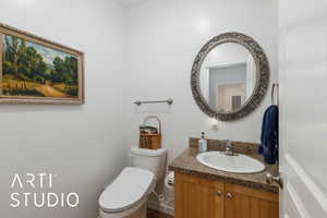 Half bath featuring vanity and toilet