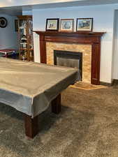 Playroom featuring carpet flooring, a fireplace, and billiards