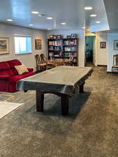 Rec room with a textured ceiling, carpet, billiards table, and recessed lighting