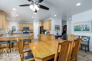 Dining area featuring recessed lighting, stone tile floors, and ceiling fan