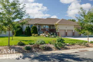 Ranch-style house featuring a front yard, concrete driveway, stucco siding, and a garage