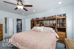 Carpeted bedroom featuring recessed lighting, a spacious closet, and ceiling fan