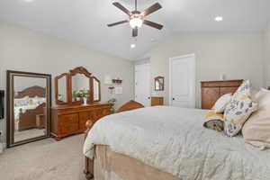 Bedroom featuring lofted ceiling, light carpet, recessed lighting, a closet, and a ceiling fan