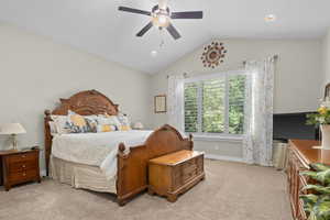 Bedroom with light carpet, vaulted ceiling, ceiling fan, and recessed lighting