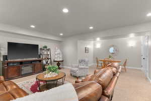 Carpeted living room with recessed lighting