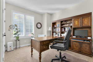 Office area with light carpet and baseboards