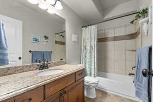 Full bath featuring shower / tub combo, vanity, and light tile patterned floors