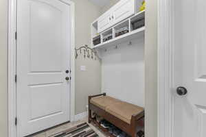Mudroom featuring light tile patterned floors and baseboards