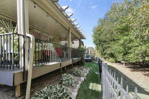 View of side of home with a deck