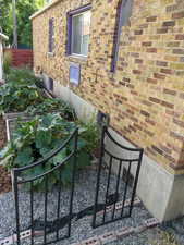 Exterior view of brick siding and a garden