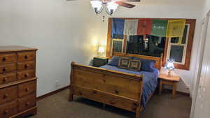 Carpeted bedroom with baseboards and a ceiling fan