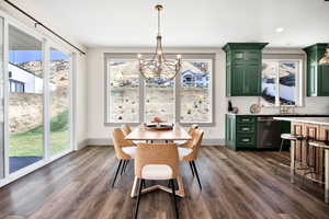 Dining room featuring a chandelier, dark wood-style flooring, and recessed lighting
