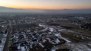 Aerial view at dusk of agricultural area, a mountain view, and a residential view