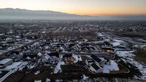 Snowy aerial view with a mountain view and a residential view